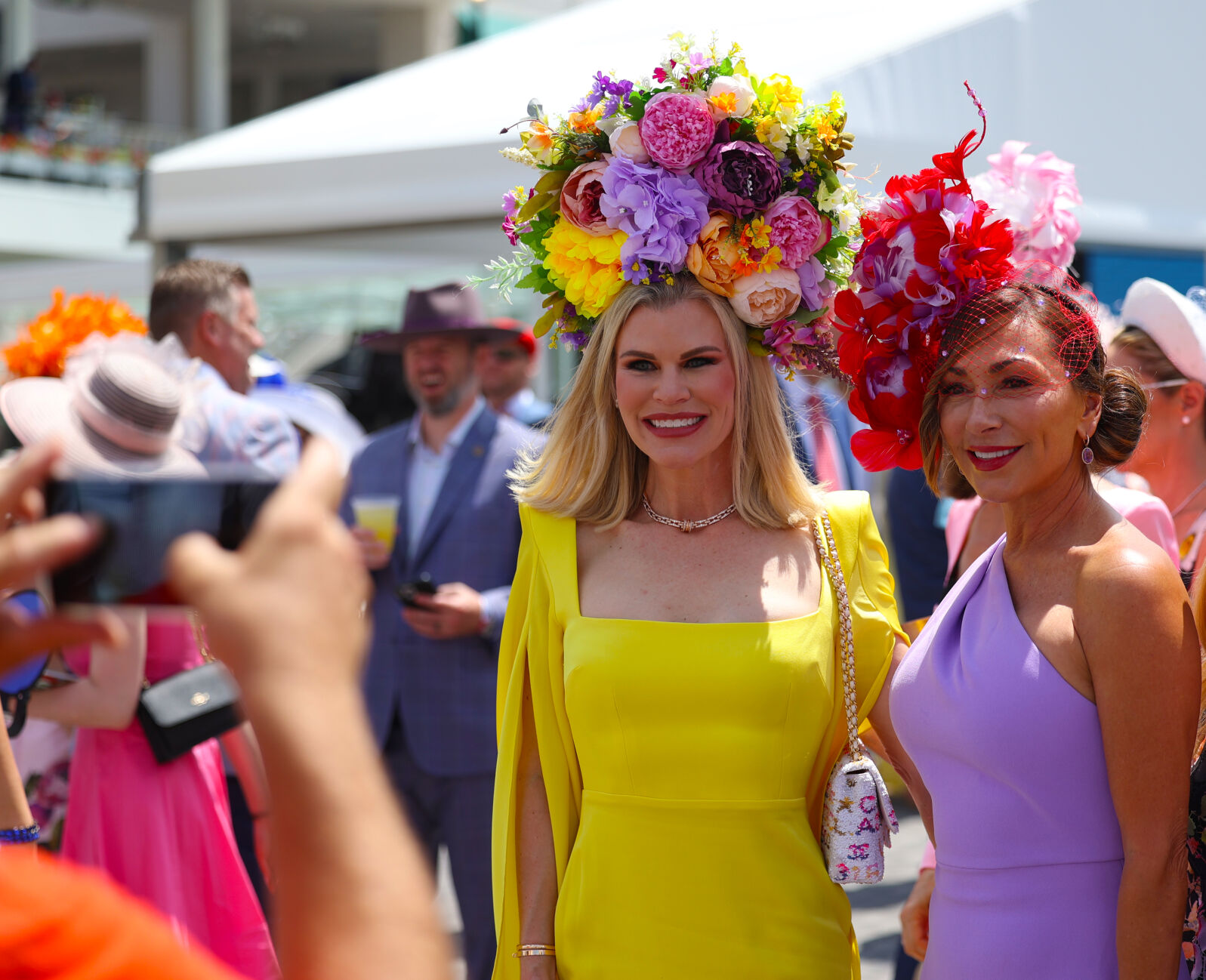 Woman poses for photo with flowers hat.JPG